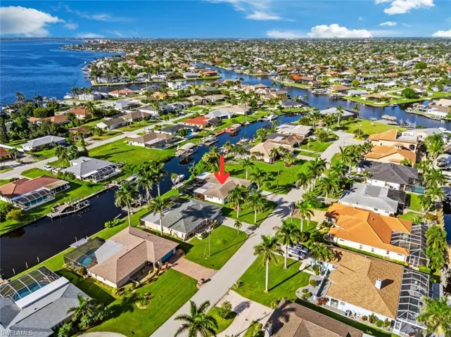 Aerial view of residential area featuring a nearby body of water