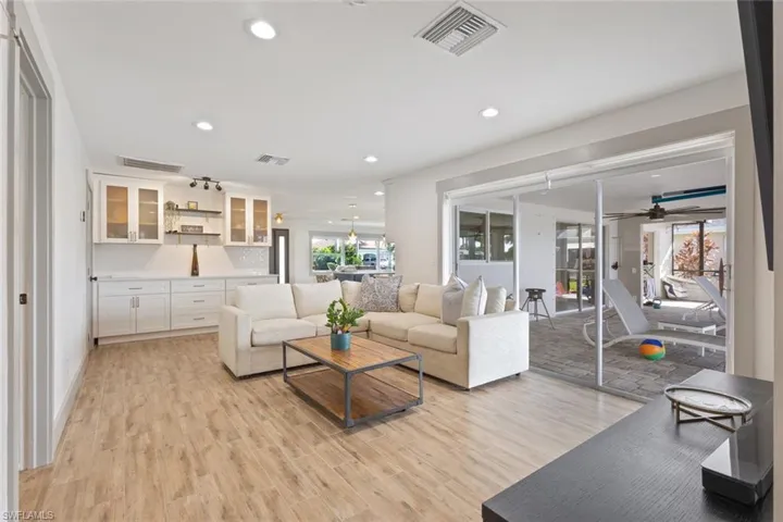 Living area with light wood-type flooring, recessed lighting, and ceiling fan