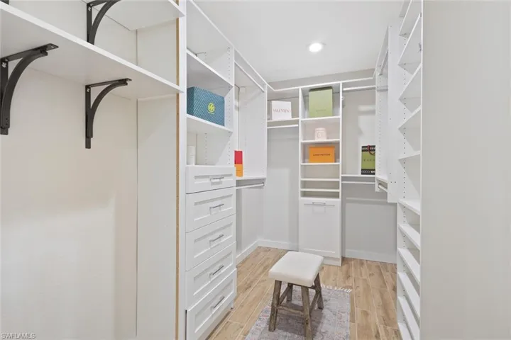 Spacious closet with light wood-style floors