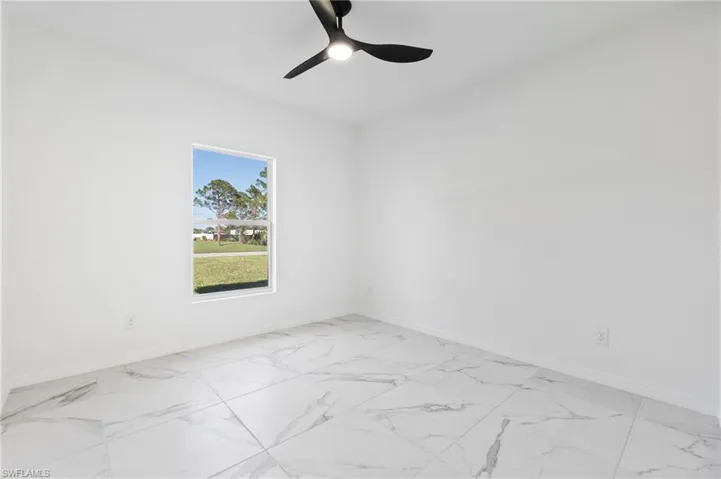 Spare room with ceiling fan