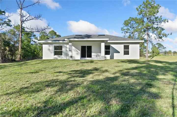 Back of property with a yard