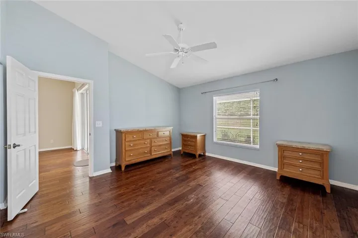 Unfurnished bedroom featuring dark wood-type flooring and ceiling fan