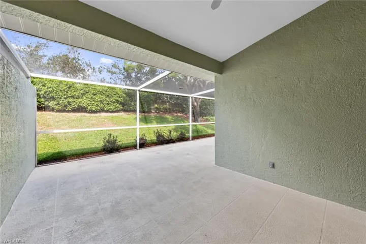 View of patio featuring a lanai