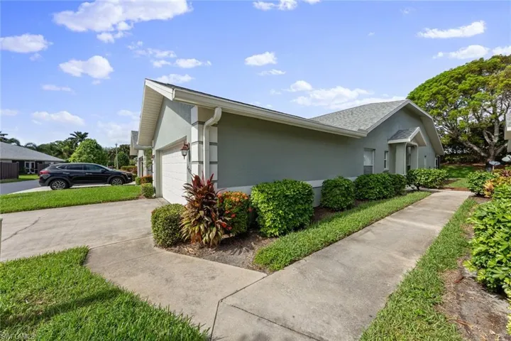 View of side of property with a garage