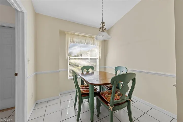 Dining space with light tile patterned flooring