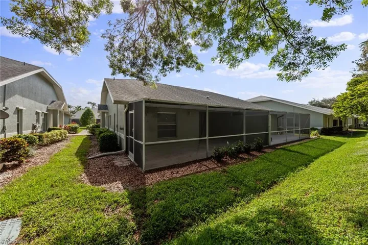 Rear view of property with a yard