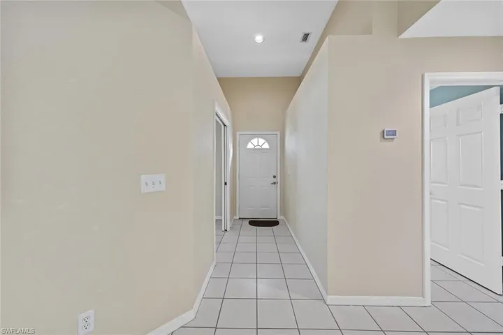 Hall with light tile patterned flooring