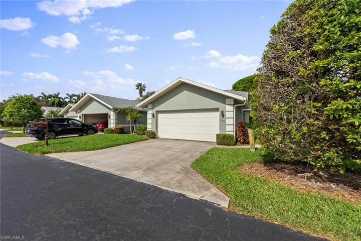 Ranch-style home with a garage and a front yard