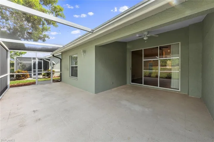View of patio with a lanai and ceiling fan