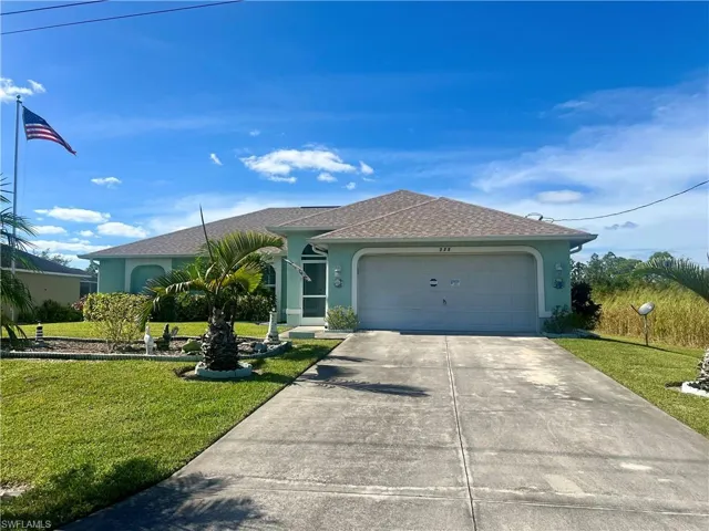 Ranch-style house with a front yard and a garage with plenty pf parking.