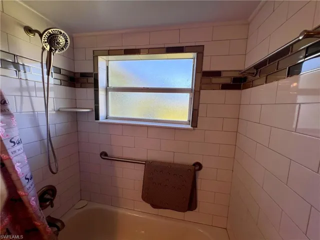 Bathroom with shower / bath combo with shower curtain