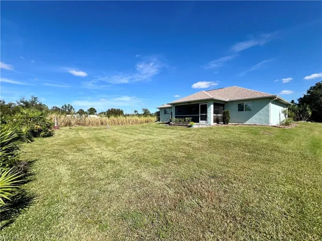 View of backyard with a screened lanai.