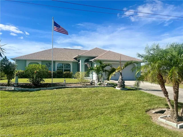 View of front of home featuring a garage and a nicely landscaped front yard