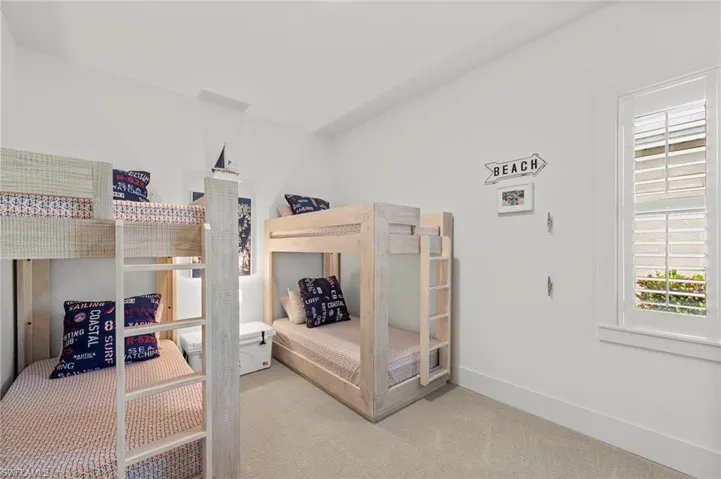 Current bunk room can be converted back to a THIRD GARAGE BAY. Bedroom with baseboards and carpet floors New LIGHT FIXTURE (November 2018),