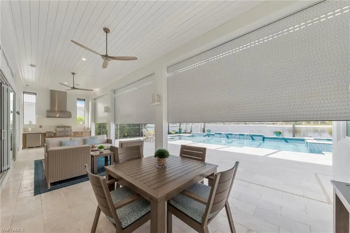 Dining space featuring ceiling fan and wooden ceiling New OUTDOOR KITCHEN (December 2018), New electric Storm Smart HURRICANE SHUTTERS (March 2019), New SHIPLAP CEILING & CROWN MOLDING (May 2020), New CEILING FAN (October 2024)