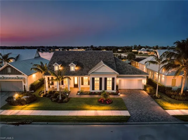 View of front of house featuring a porch, decorative driveway, an attached garage, and a front lawn  New VITEX SMART HOME AUTOMATION SYSTEM (November 2019), New LANDSCAPE LIGHTING (February 2019)