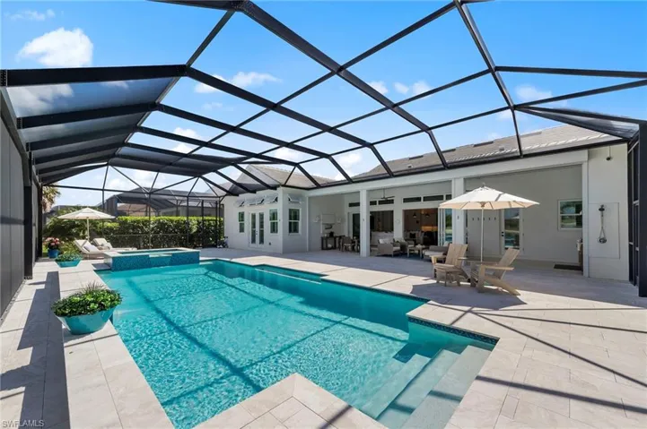 Integrated pool / hot tub featuring a sunroom, a patio, and a lanai