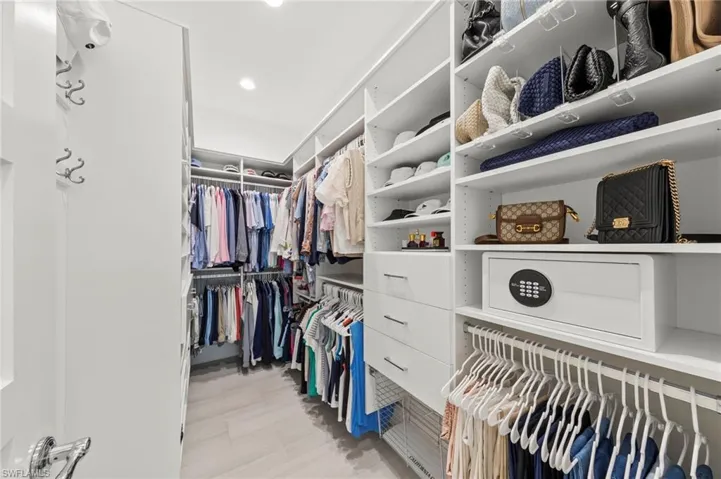 View of walk in closet New OCCUPANCY SENSOR (December 2019), New CUSTOM CALIFORNIA CLOSET ORGANIZERS (February 2020)