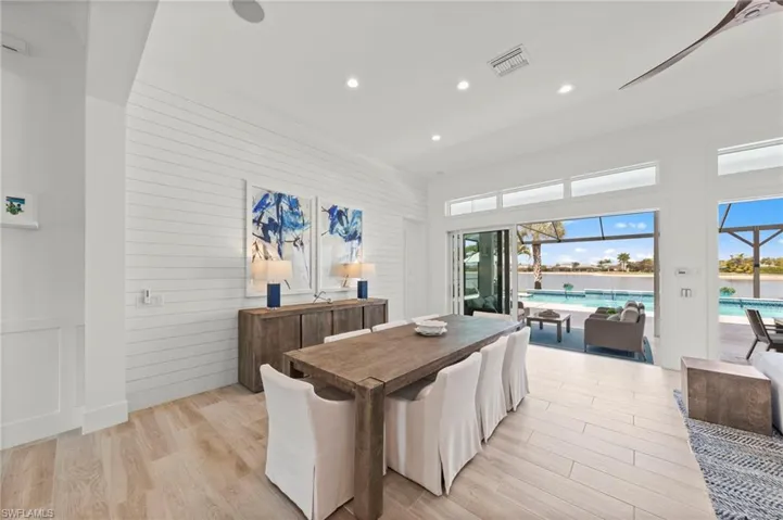 Dining area featuring a sunroom, recessed lighting, light wood-style flooring, and wood walls New SHIPLAP WALLS (May 2020New CEILING FAN (October 2024)