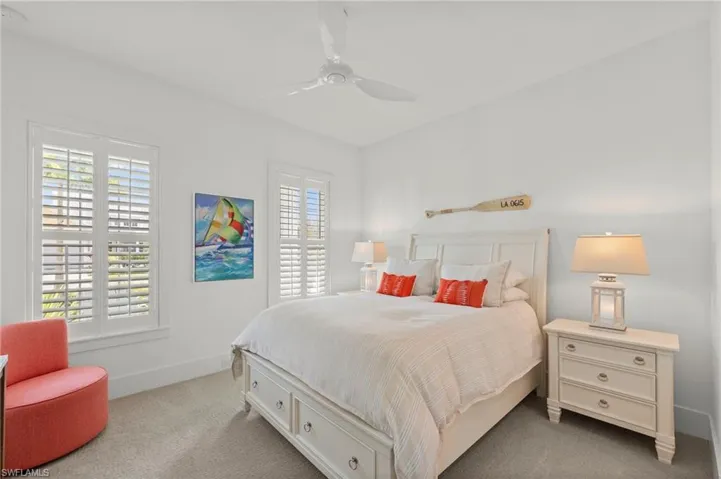 Bedroom featuring ceiling fan, multiple windows, and carpet flooring New CEILING FAN (November 2018)