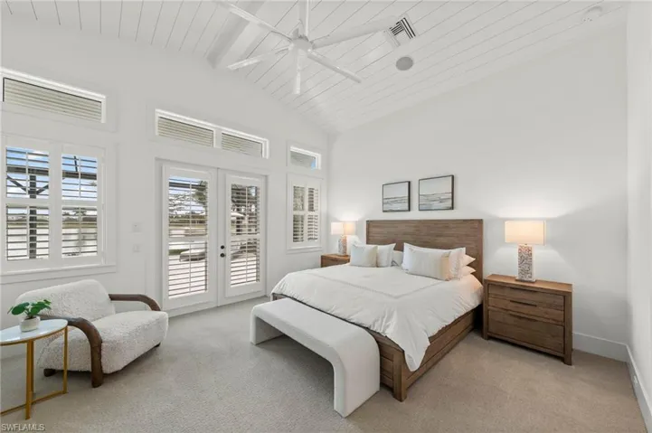 Bedroom with access to exterior, carpet, ceiling fan, a high wooden beamed ceiling, and french doors New CEILING FAN (November 2018)