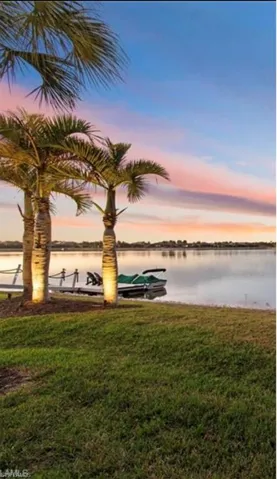 Water view with a boat dock, sunset sky and long lake views.