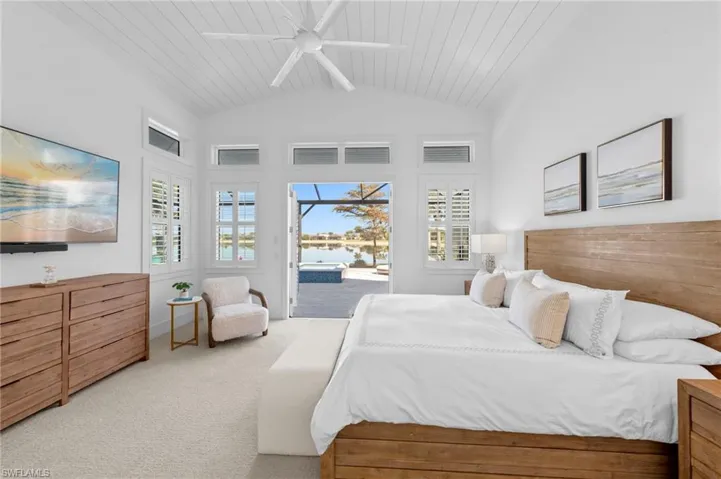 Carpeted bedroom with access to outside, multiple windows, ceiling fan, a sunroom, and lofted ceiling with beams      New MOUNTED TV & SONOS SOUND BAR (November 2018), New CEILING FAN (November 2018)