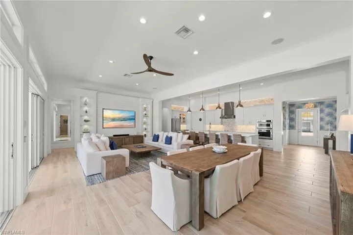 Living room featuring light wood-style floors, recessed lighting, and a ceiling fan New MOUNTED TV & SONOS SOUND BAR (November 2018), New KITCHEN PENDANTS (November 2018), New SHIPLAP BUILT-IN & WALLS (May 2020), New KITCHEN INTERIOR PAINT (July 2023)New CEILING FAN (October 2024)