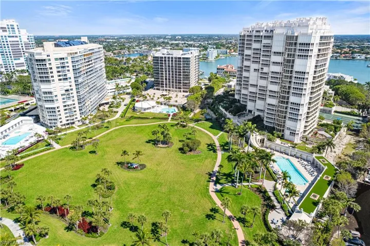 View of urban area with a pool and a large body of water