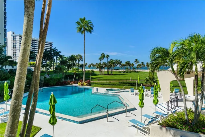 Community pool featuring a community hot tub and a patio
