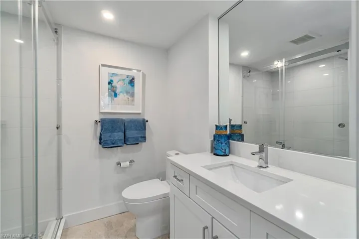 Bathroom with vanity, a shower stall, light tile patterned floors, and recessed lighting