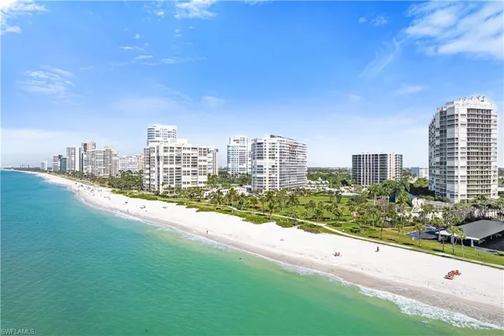 Aerial view of city skyline and waterfront with a beach