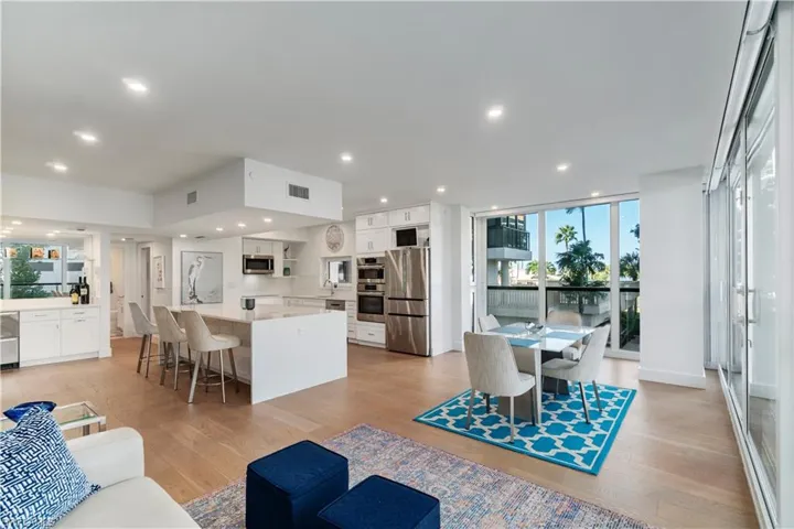 Living room featuring light wood-style floors, recessed lighting, and floor to ceiling windows