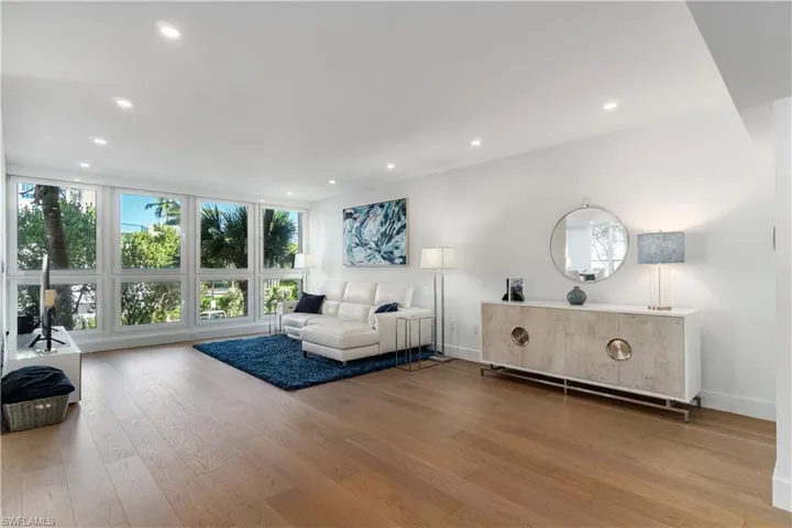 Living area with recessed lighting and light wood finished floors