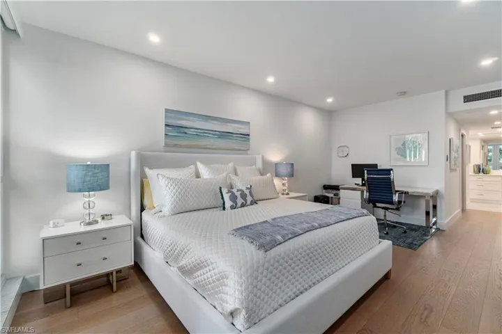 Bedroom featuring an office area, light wood-style flooring, and recessed lighting