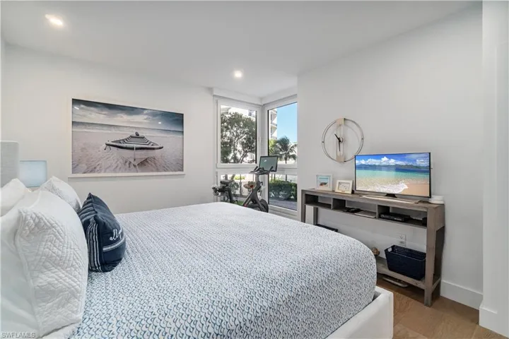 Bedroom with light wood-type flooring and recessed lighting