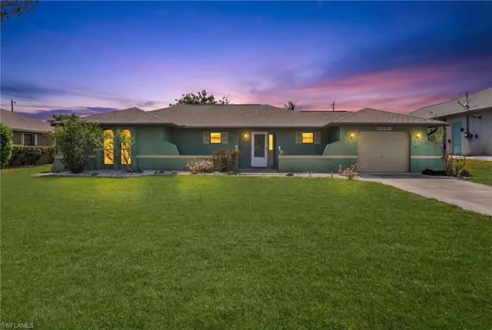 Single-story residence featuring a stucco exterior and an attached single-car garage
