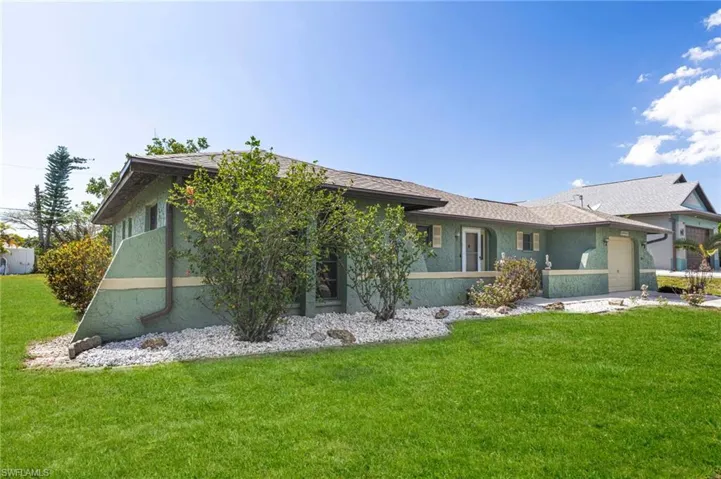 Exterior with stucco finish and a shingle roof