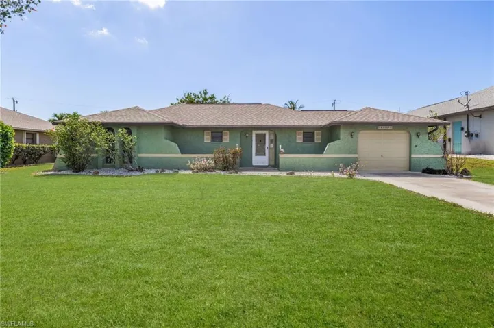 Ranch-style exterior with a stucco finish, attached single-car garage, front entry with a full light door, and a concrete driveway