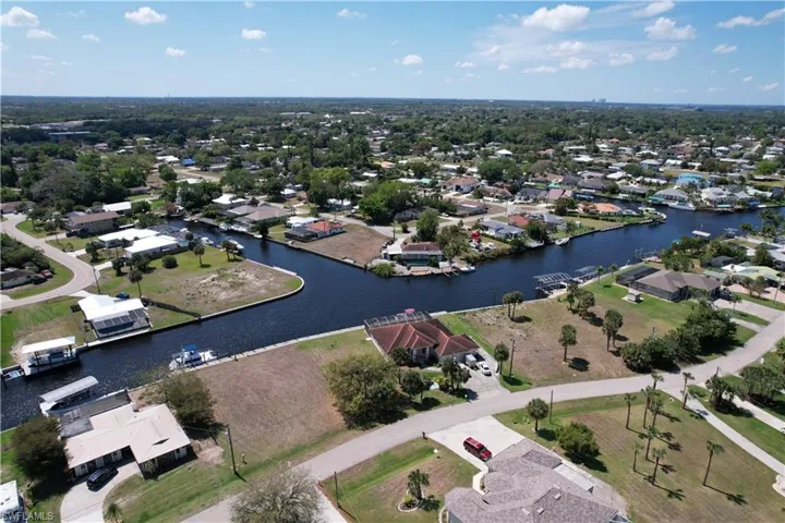 Aerial view of property's location featuring nearby suburban area and a nearby body of water