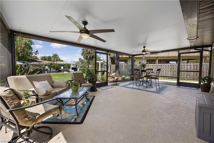 Sunroom / solarium with outdoor dining area, a patio area, ceiling fan, and healthy amount of natural light