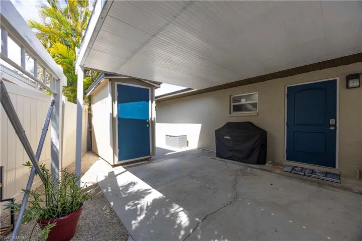 Fenced backyard with a storage shed and a patio