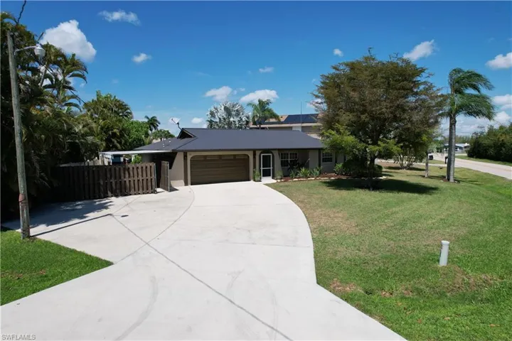 Ranch-style home with an attached garage and concrete driveway