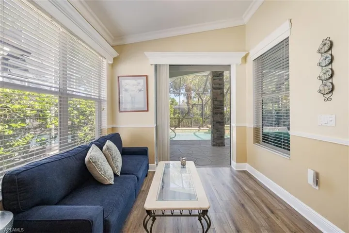 Sitting room featuring ornamental molding, wood finished floors, and a wealth of natural light