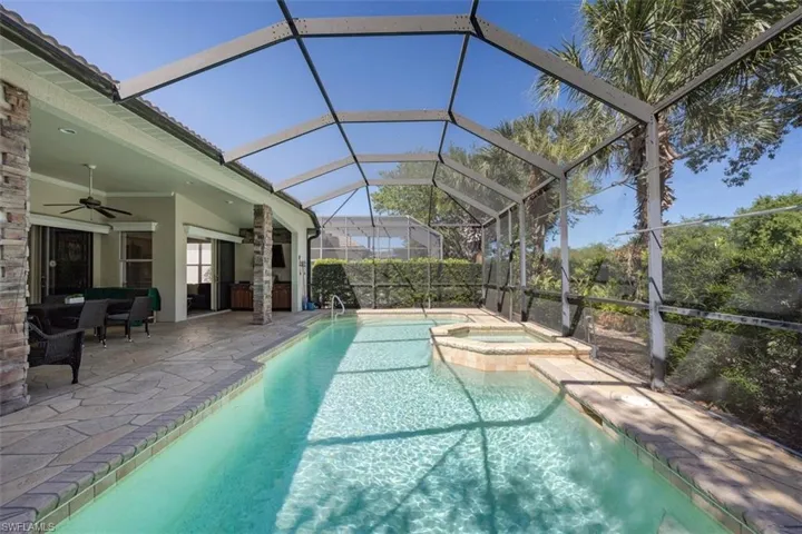 Pool with an in ground hot tub, a patio, and a ceiling fan