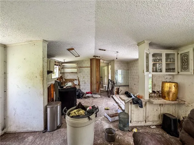 Living room with healthy amount of natural light and a textured ceiling