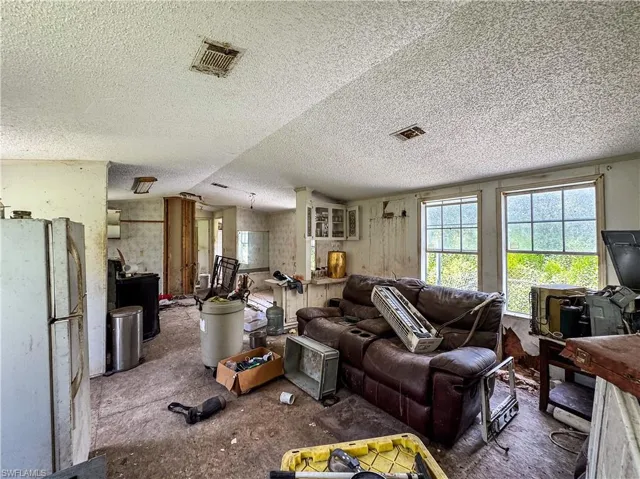 Living room with plenty of natural light and a textured ceiling