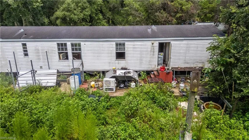 Back of house with a shingled roof
