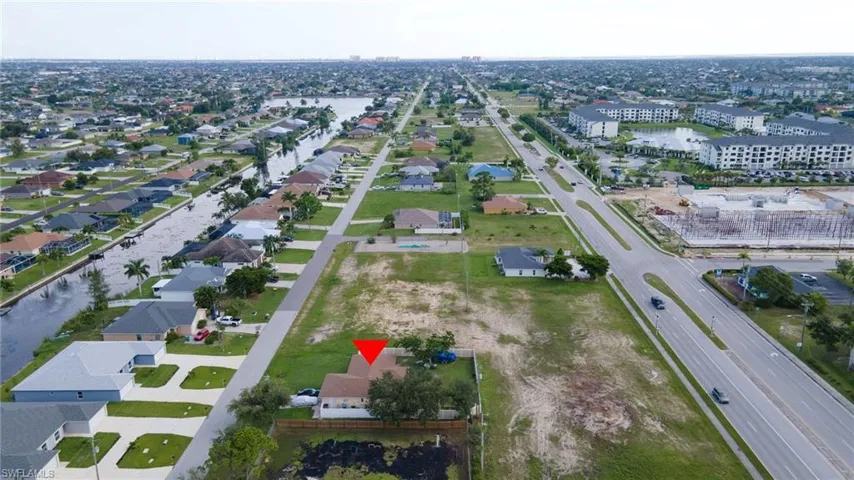 Single story home with a garage and a front lawn