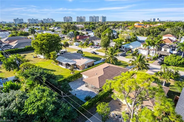 Aerial view of residential area featuring city skyline